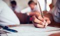 close-up-student-holding-pencil-writing-final-exam-examination-room-study-classroom-vintage-style_73622-242